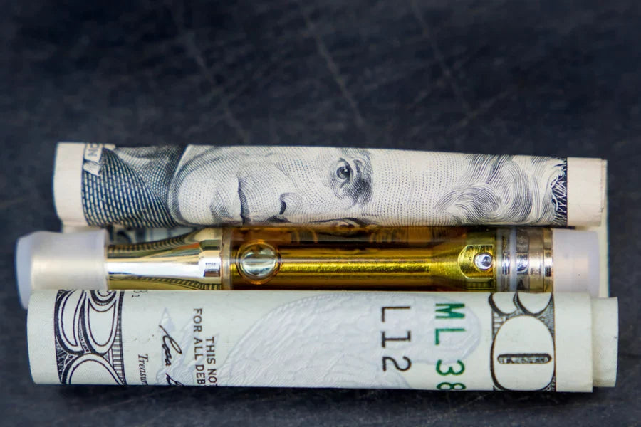 A cart sitting on a rolled-up $20 bill.