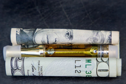 A cart sitting on a rolled-up $20 bill.