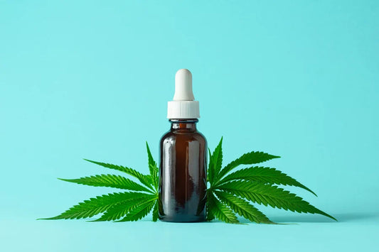 THC tincture on an aqua background.